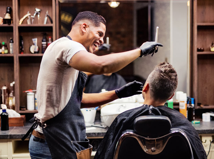 man getting a haircut from a barber